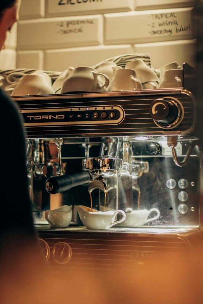 A coffee machine brewing espresso in a warm, inviting cafe setting.